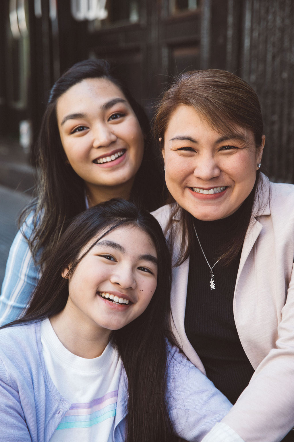 Mother and daughters smiling