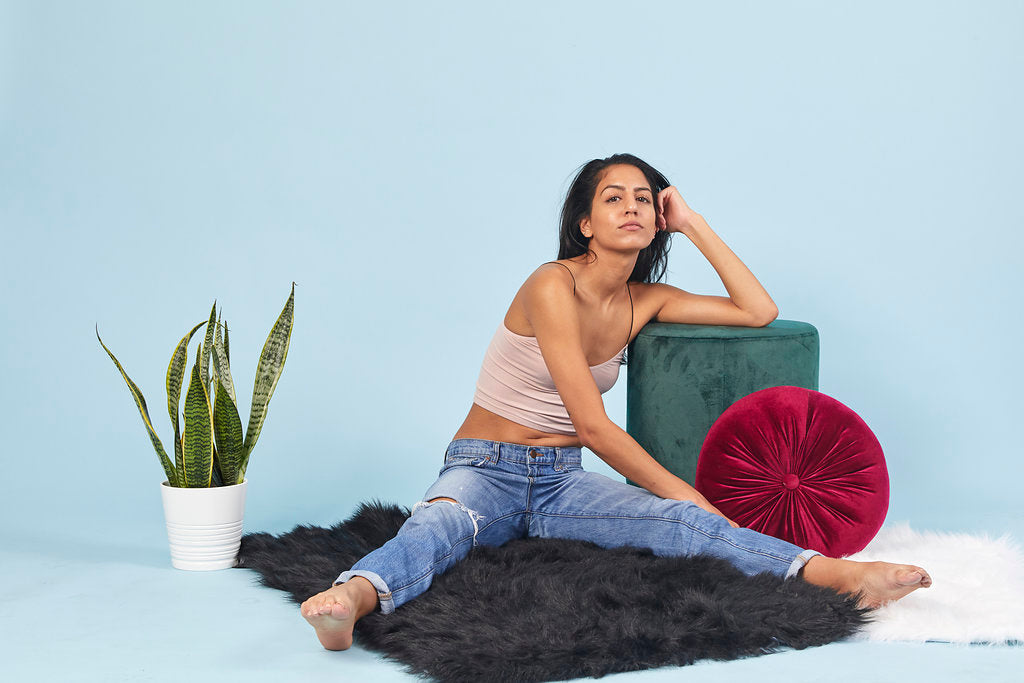 Woman wearing jeans sitting on carpet floor
